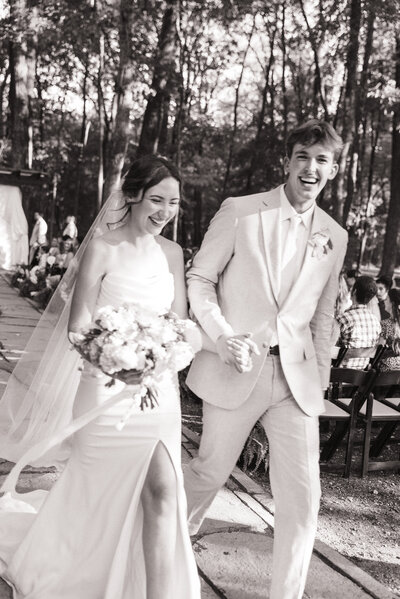 bride and groom walking down the aisle after getting married