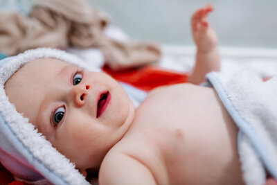 A baby after the bath in his towel