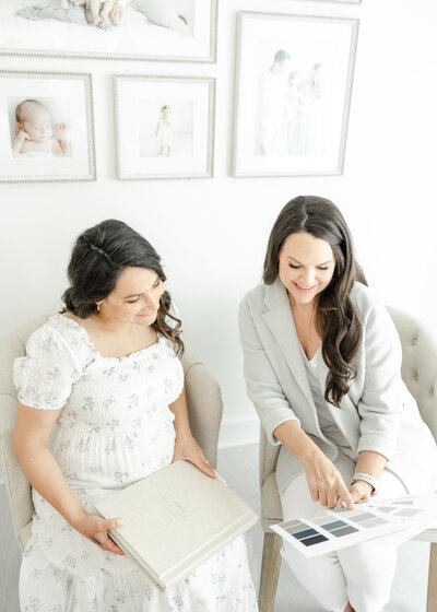 Connecticut family photographer, Kristin Wood, shows a mother her photo album cover options