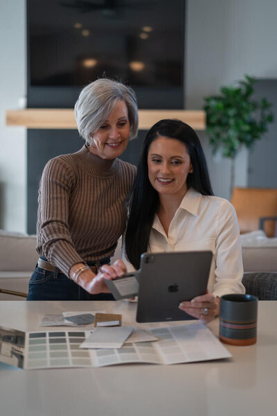 two women looking at an ipad