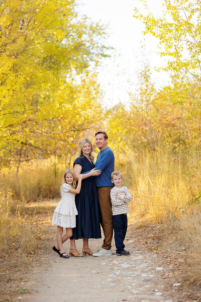 Family of 4 on a path near the Boise Greenbelt.