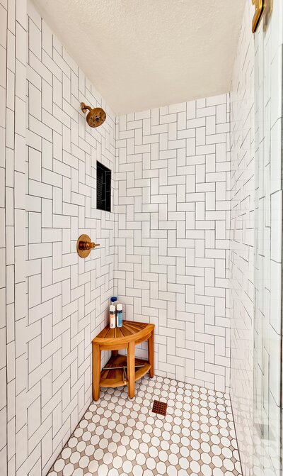 Shower in a bathroom of this two-bedroom, two-bathroom vacation rental condo in the historic Behrens building in downtown Waco, TX just blocks from the Silos, Baylor University, and Spice Street.