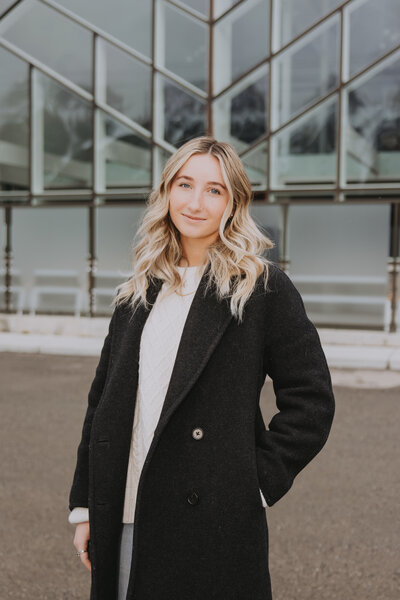 Rocky Mountain Weddings Creative Director inside smiling in The Gem Event Centre Located By Banff and Canmore