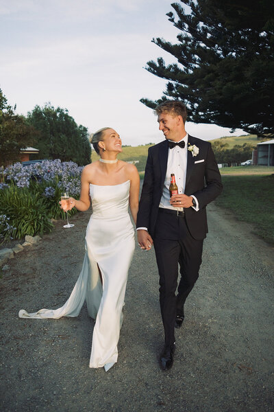 bride and groom hold hands on wedding day in adelaide