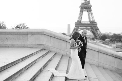 husband and wife sitting in an old rolls royce with their foreheads touching and smiling at one another