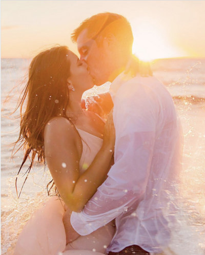 Couple kissing in the ocean after proposal portraits in Wailea by Love + Water