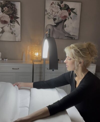 Kathleen preparing a table for a facial