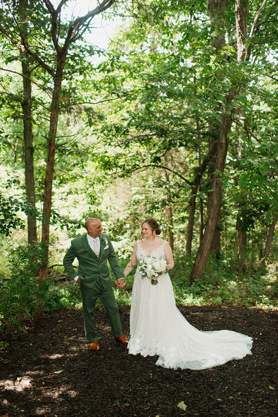 Wedding couple in the field near forest wedding venue in PA.
