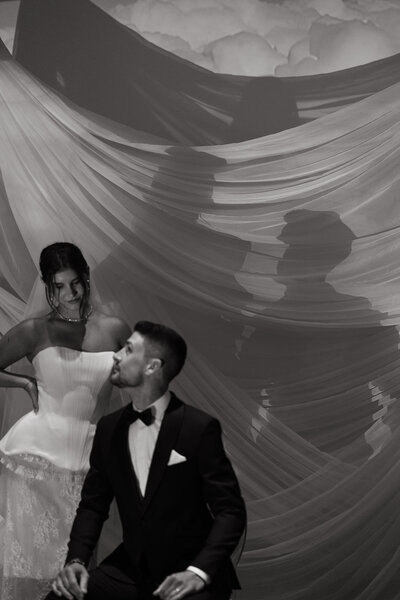 Bride hugging a guest during cocktail hour at a lakeside wedding — emotional, documentary-style wedding photography capturing real connection.