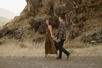 Couple enjoying a romantic engagement session in the Columbia River Gorge, with breathtaking views of the river, cliffs, and surrounding nature.