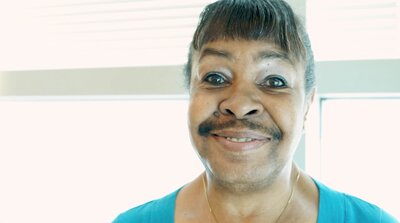 a woman with bangs smiling