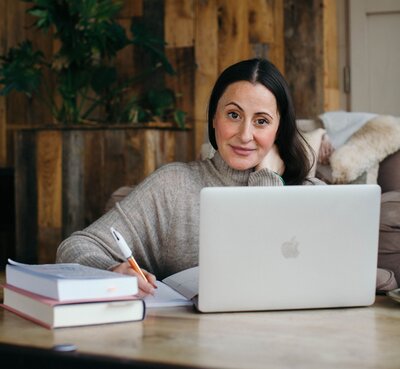 mariella at a desk with a laptop