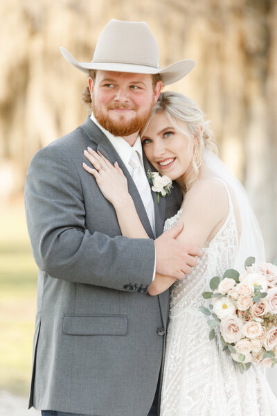 Couple smiling off into the distance on wedding day