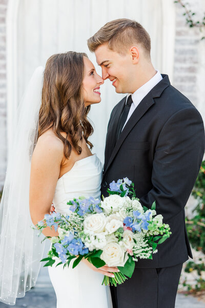 a bride and groom touching noses