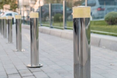 Stainless steel bollards installed by HERN Linemarking in a Brisbane commercial precinct, with road furniture services available across Tweed, Gold Coast, and Northern NSW.