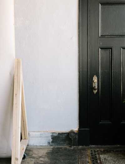 black door with ornate brass detail and knob, Detroit, Michigan film brand photography