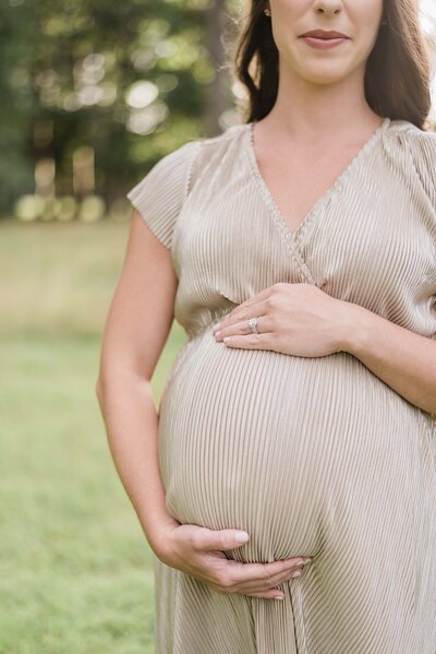 maternity portrait of both holding stomach in richmond