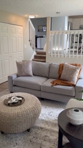 Cozy living room with layered neutrals and woven textures by KSC Interiors.