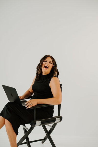 Online business owner holding phone, ready to scale with strategic marketing systems and consistent content