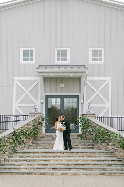 bride and groom outside of barn venue