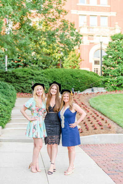 Johns Hopkins grads smile on the Johns Hopkins Medical Campus during Johns Hopkins Grad session