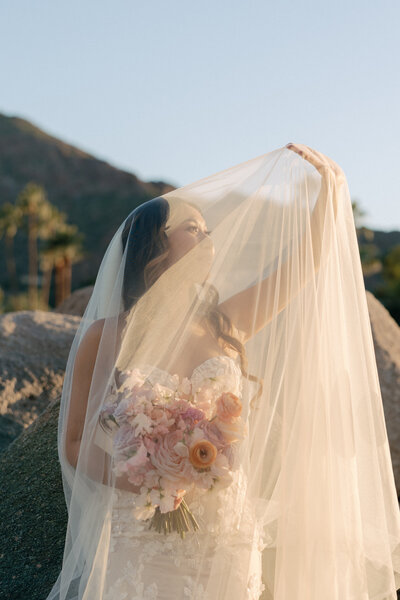 Beautiful bride with colorful bridal bouquet and veil at Mountain Shadows Resort in Paradise Valley, AZ by Snapdragon Bloom Bar.
