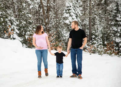 Photo of family standing together in the snow | Maternity Session