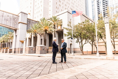 ALGO standing and talking outside courthouse