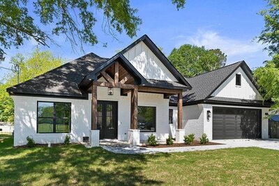 Beautiful black and white custom home with wood trim.