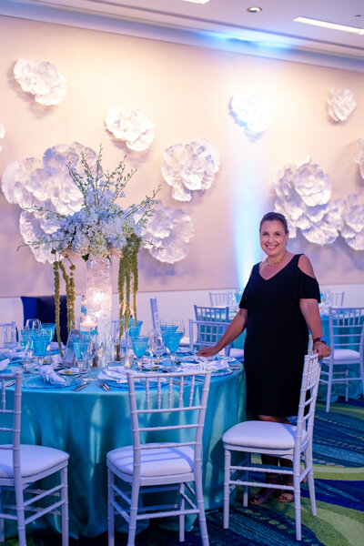 Wedding Planner Christine from Dreamday Destinations at blue and white reception space