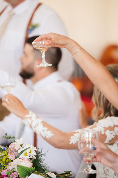 Photo of bride and groom holding champagne.