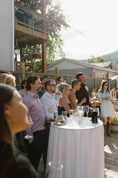 intimate moment of bride and groom during toasts captured by alberta wedding photographer