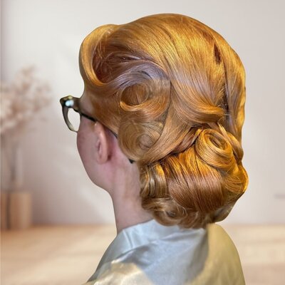 Ginger sculpted chignon with vintage-inspired pin curls and polished rolls, styled by Your Girl Friday LV for a timeless bridal look.