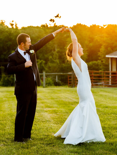 Groom twirls bride during a sunset, Baltimore wedding photographer