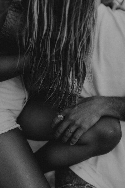 man holding womans leg