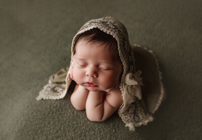Newborn baby girl in froggie pose captured by newborn photographer Candice Berman Photography