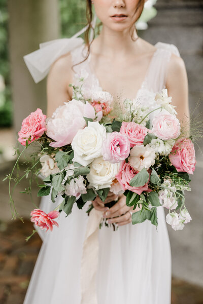 bride holding vibrant pink wedding bouquet