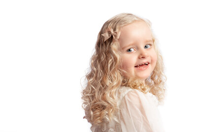Blonde curly hair with bow in