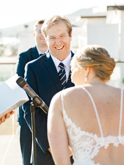 A groom laughing during vows at Surf and Sand Laguna Beach Wedding