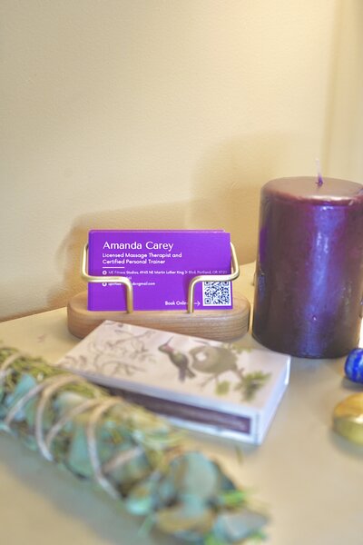 business cards and a candle displayed  on a desktop