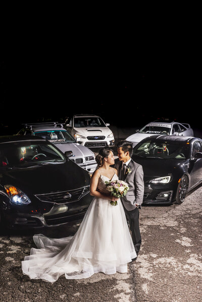 Wedding Couple outside at night with Cars
