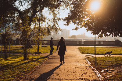 Person walking in morning sunlight—representing holistic lifestyle planning, stress management, and wellness routines