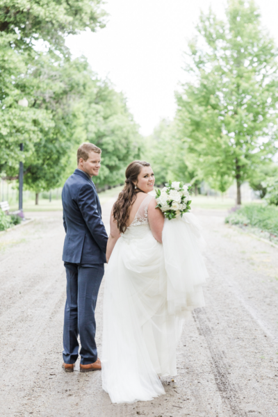 Bride and groom walking hand in hand, radiating joy and love as they begin their journey together on their wedding day in Columbus, OH.