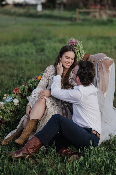 Bride and groom sit together after planning Colorado wedding.