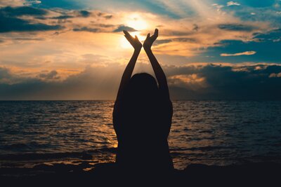woman against a sunset in Maine