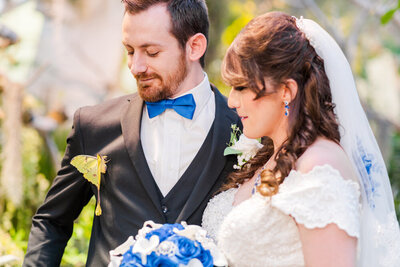 groom with butterfly on suit jacket