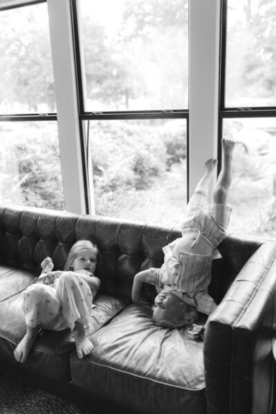 Mother and father with baby sitting on sofa at Austin family photo session