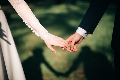Married couple holding hands