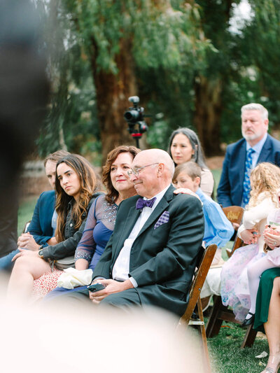 candid shot of bride's dad getting teary eyed at the ceremony