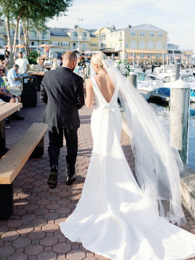 photo of bride and groom walking  towards the resort